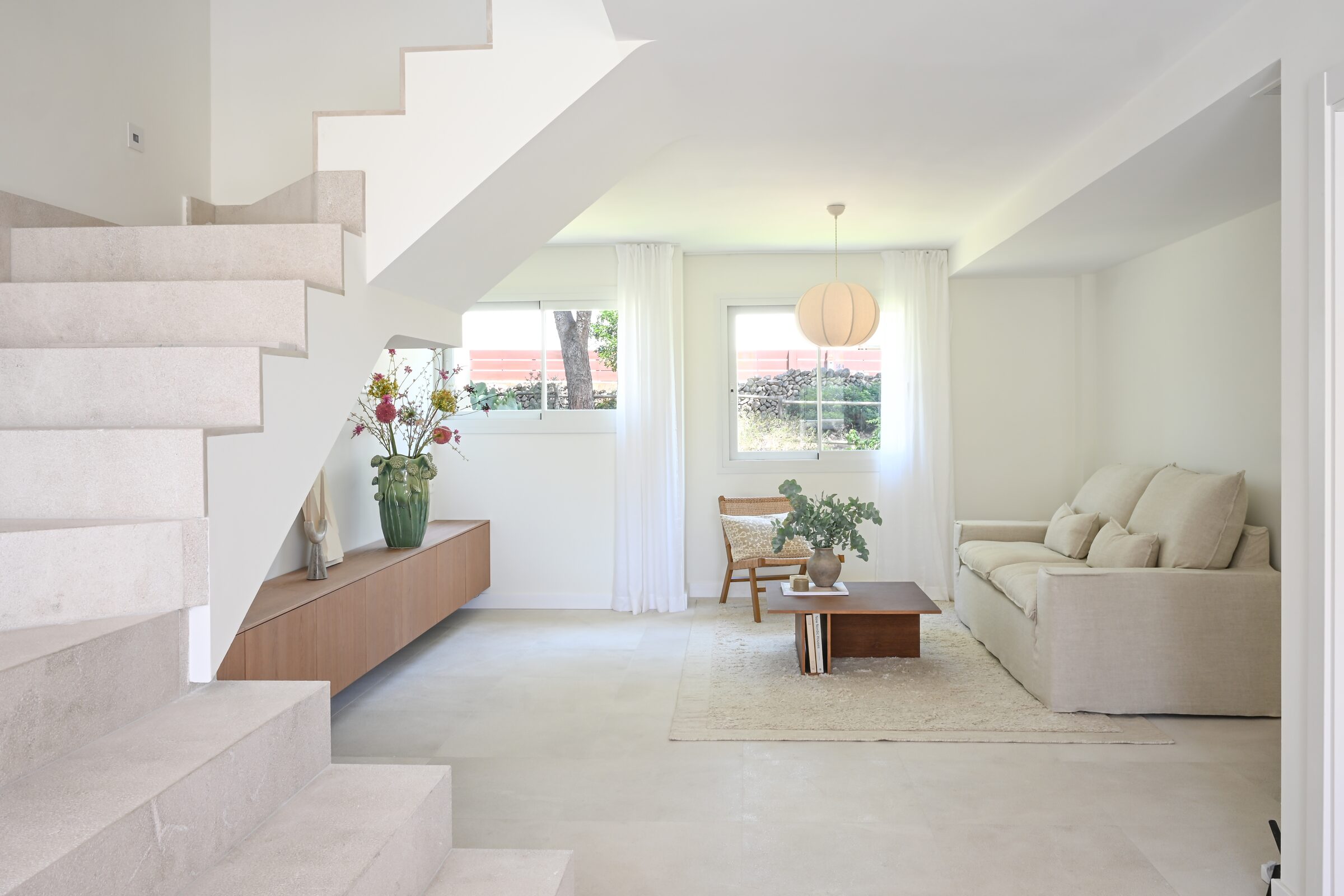 Kitchen sink island in oak and marble with the door open onto the seaview terrace.