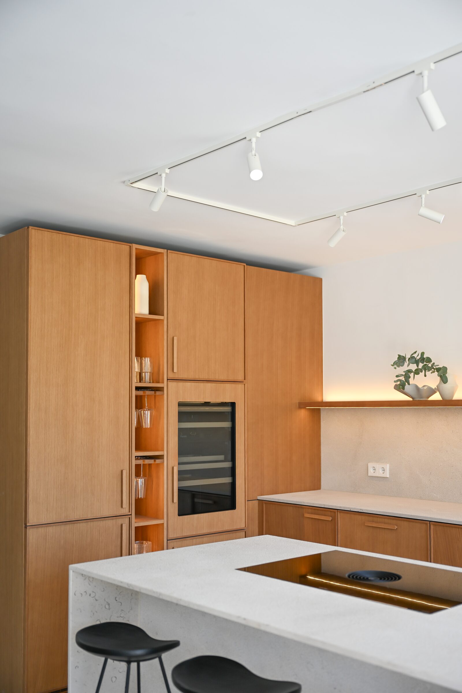 Detail of the oak kitchen shelf with hand-thrown ceramics and a brushed-bronze Quooker tap.