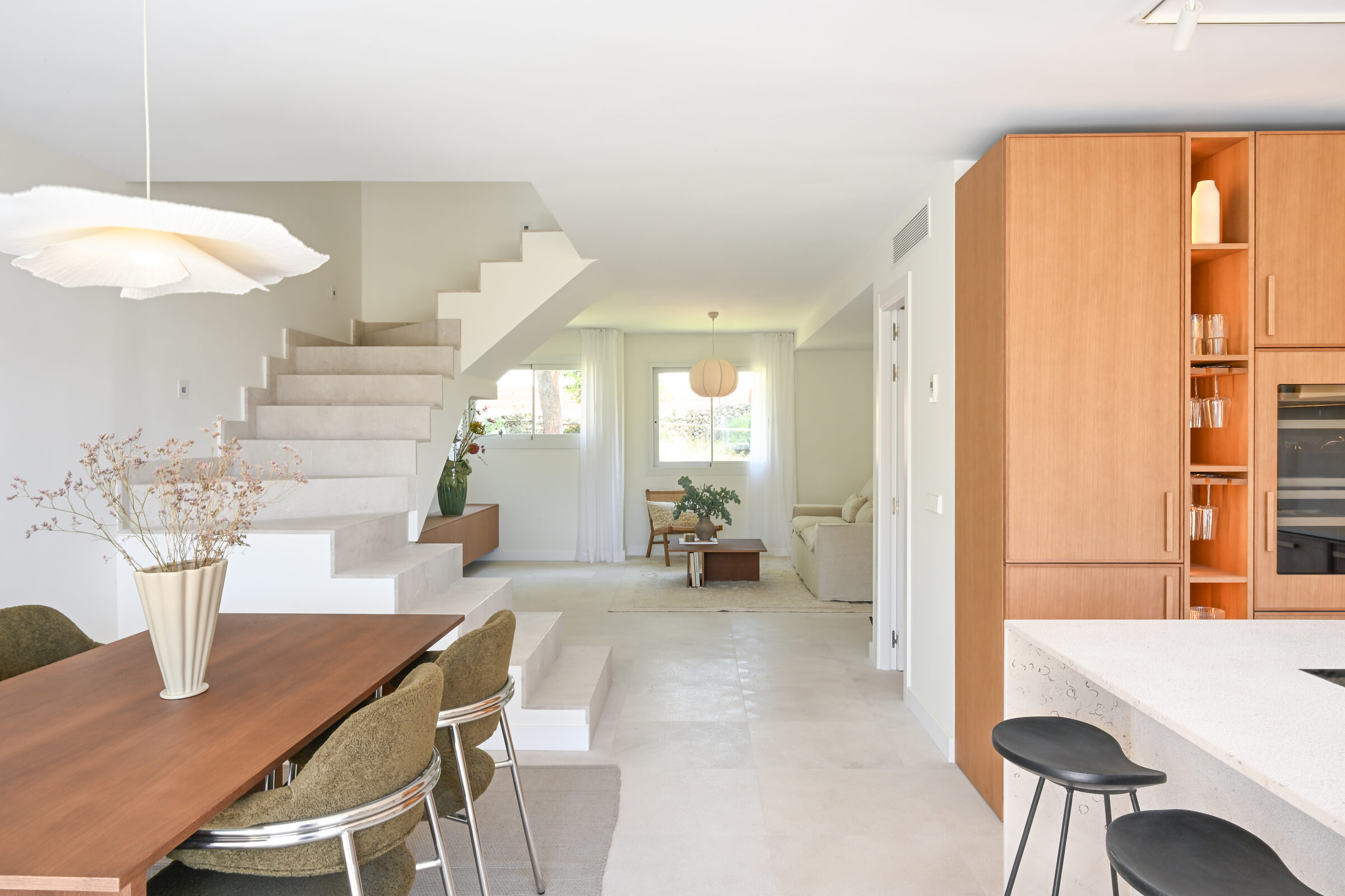 Wide view from the dining area with the walnut table and PH pendant towards the staircase and oak kitchen.