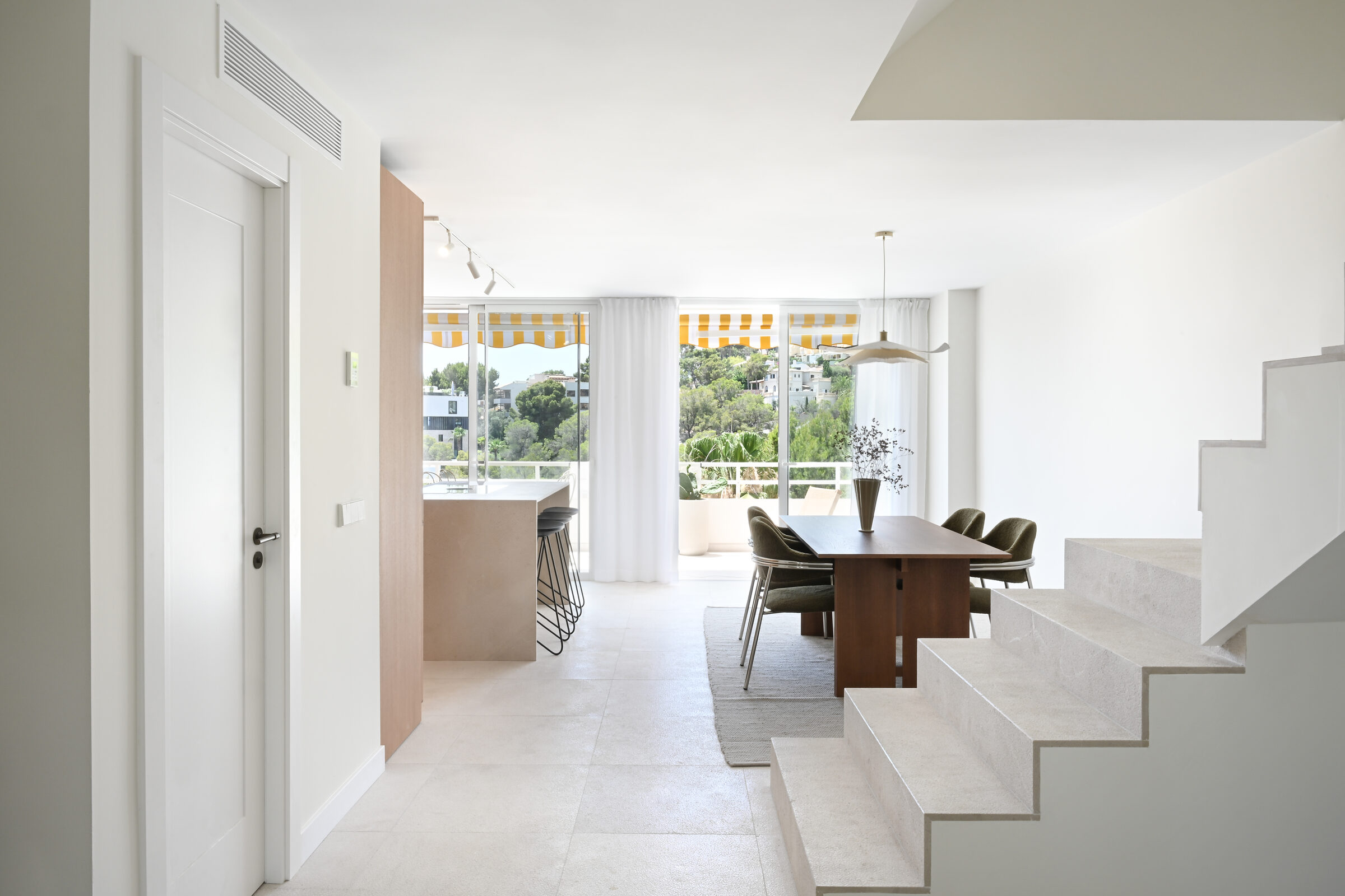 Hallway view from the entrance through the dining area to the seaview windows.