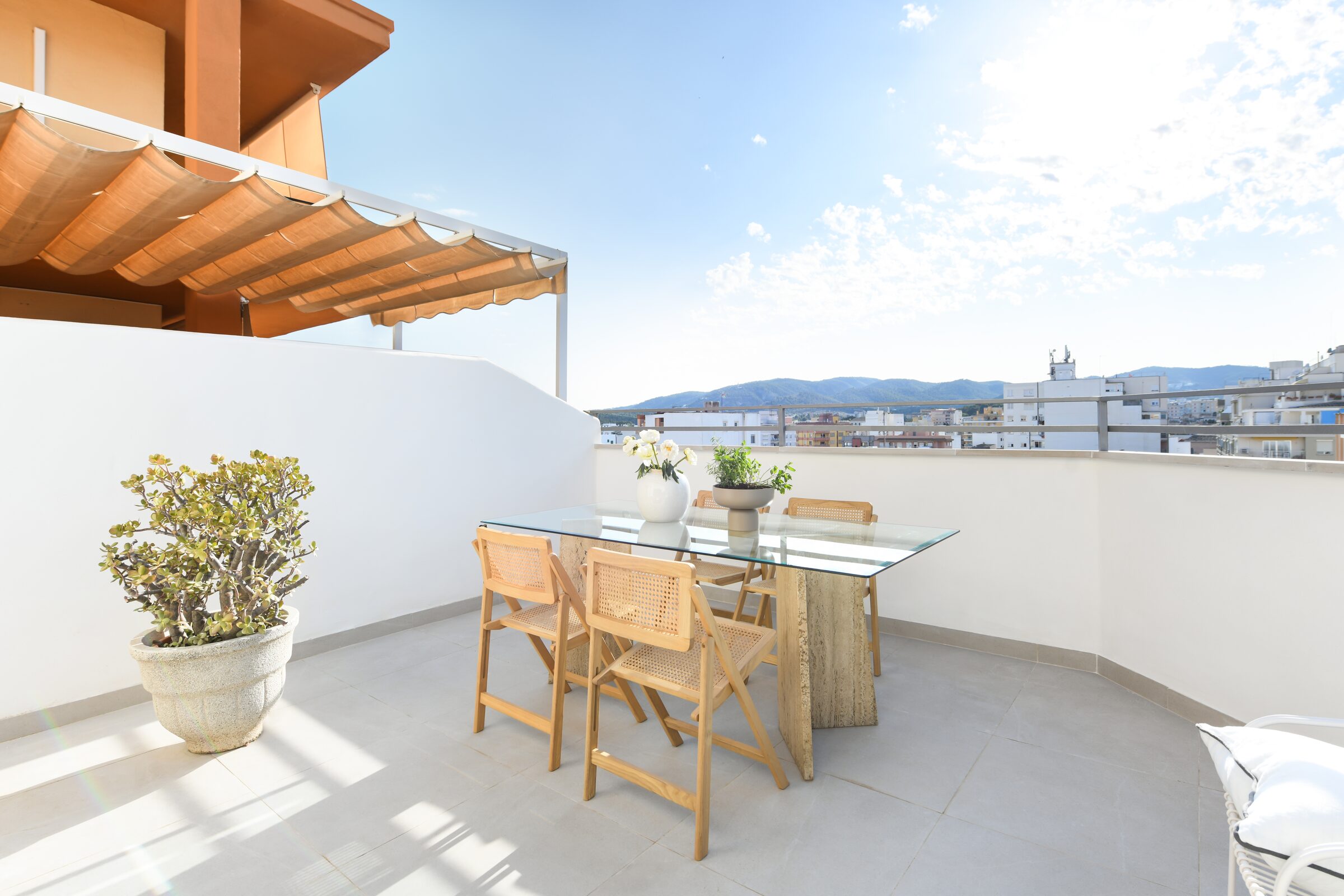 Outdoor terrace dining area with mountain and Bellver Castle views over Palma de Mallorca.