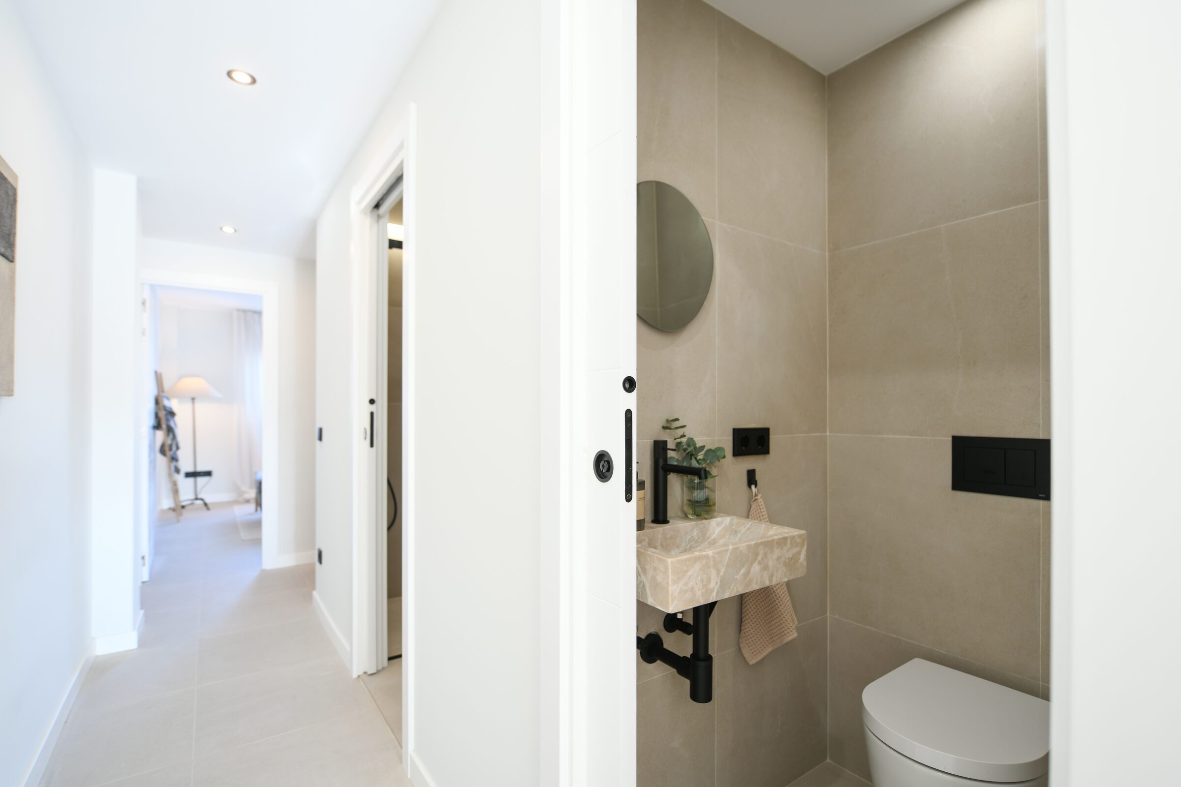 Walk-in shower clad in travertine in the main bathroom.