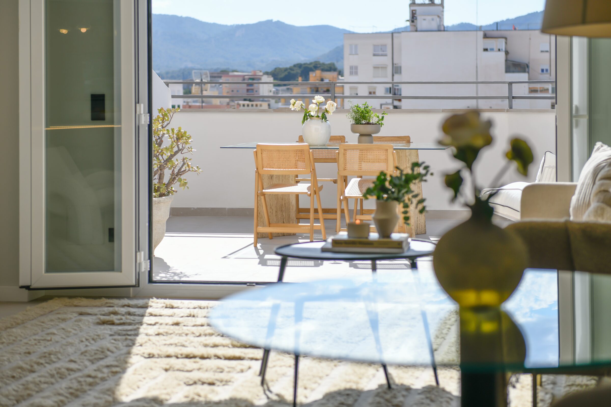 Dining area filled with natural light next to the open kitchen.