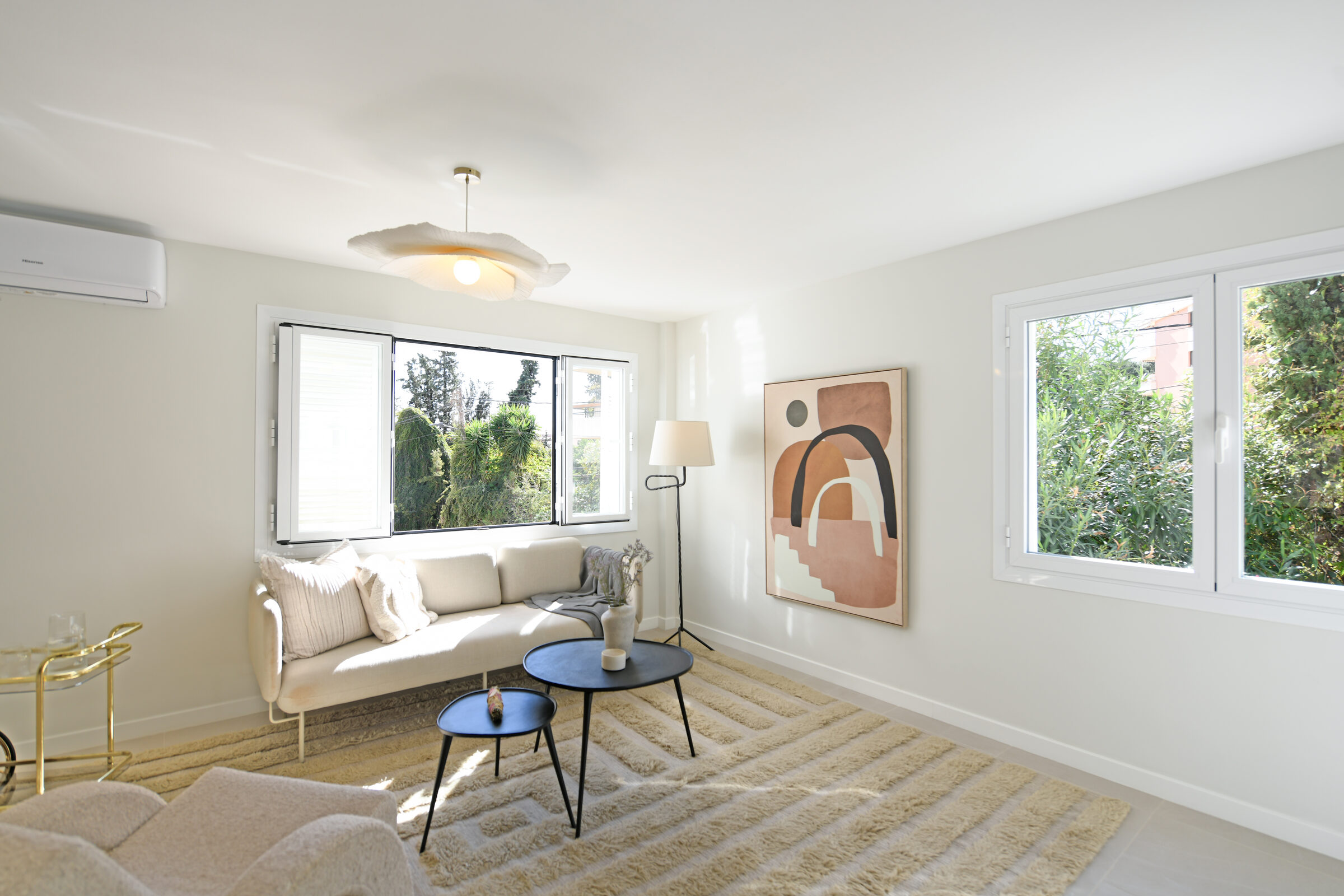 Bright living room with terracotta-toned abstract artwork and a boucle armchair.
