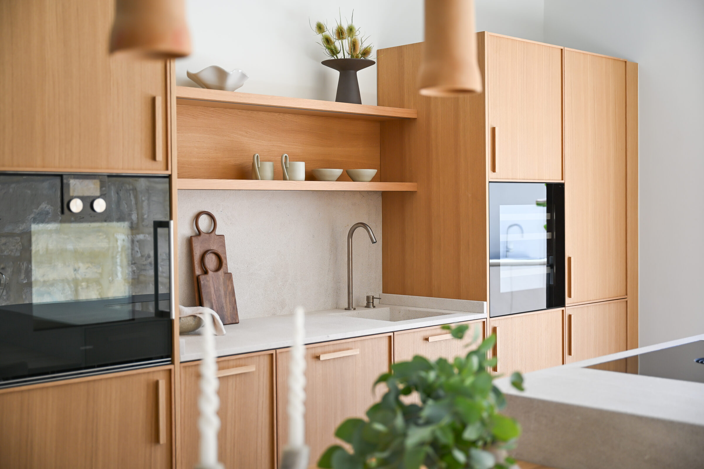 Kitchen island, oak dining table and full-height terrace doors flooded with light.