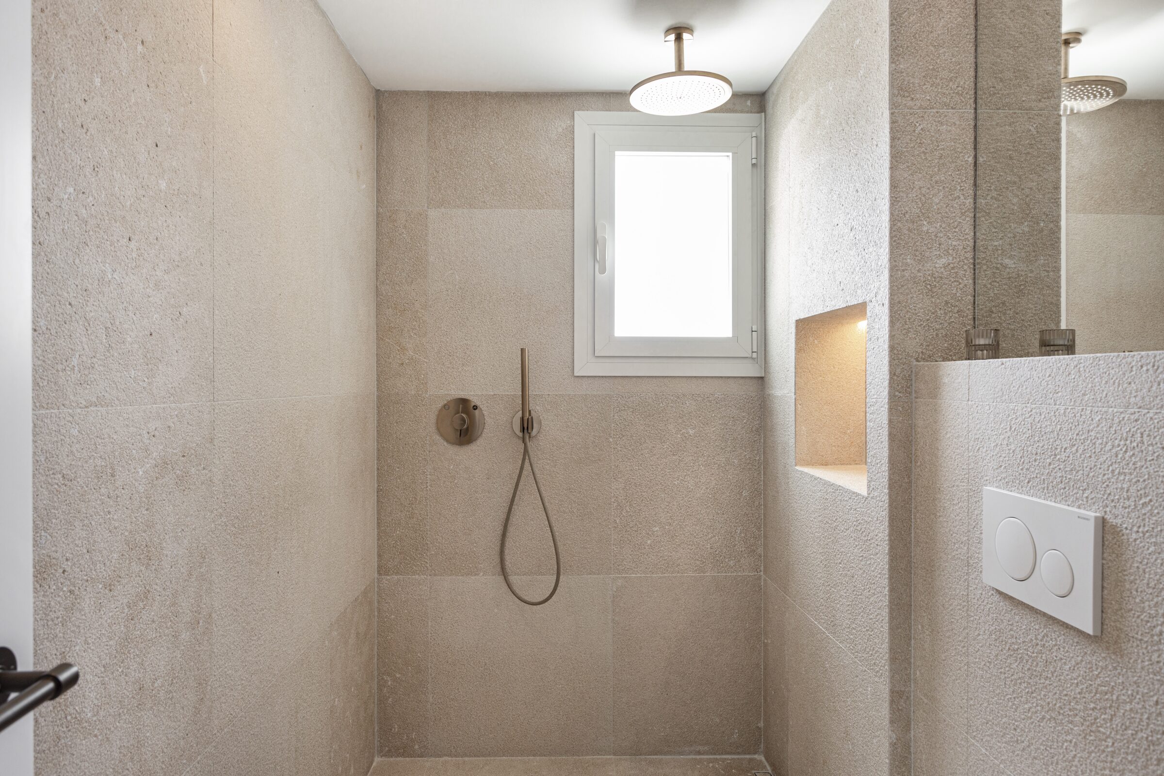 Second bathroom with walnut floating vanity, walk-in shower and a window onto the garden.